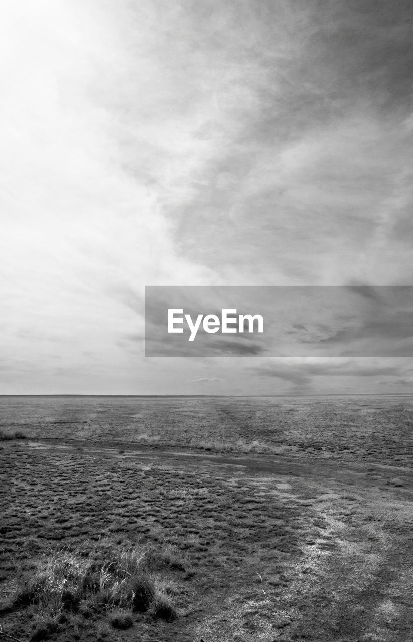 Scenic view of calm sea against cloudy sky