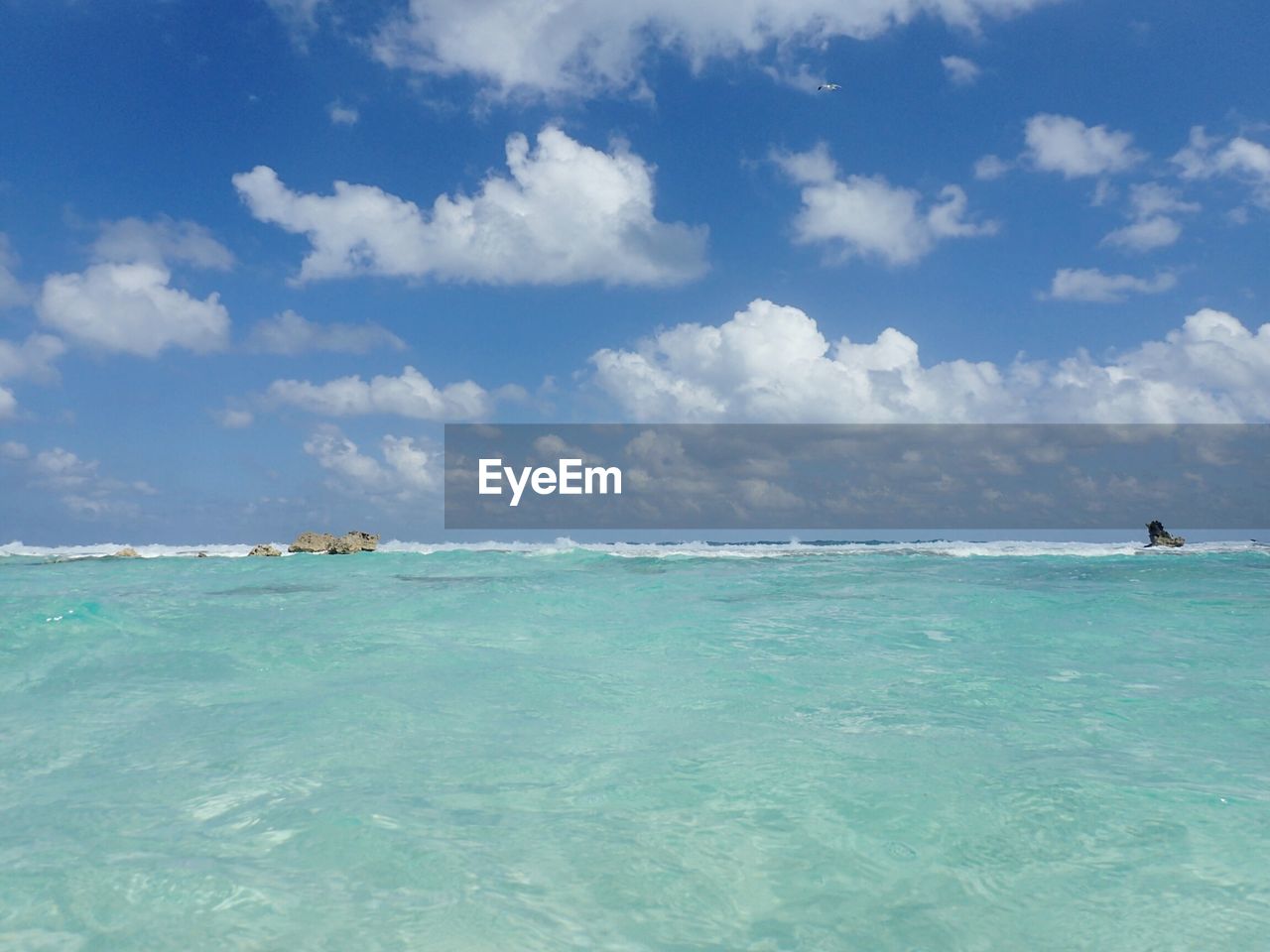 Scenic view of sea against blue sky