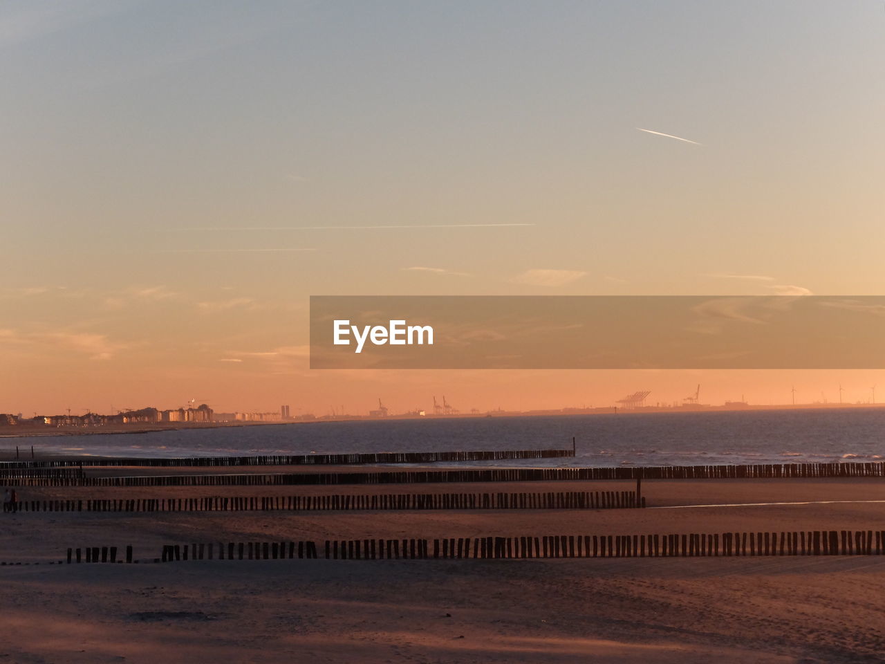 Scenic view of beach against sky during sunset