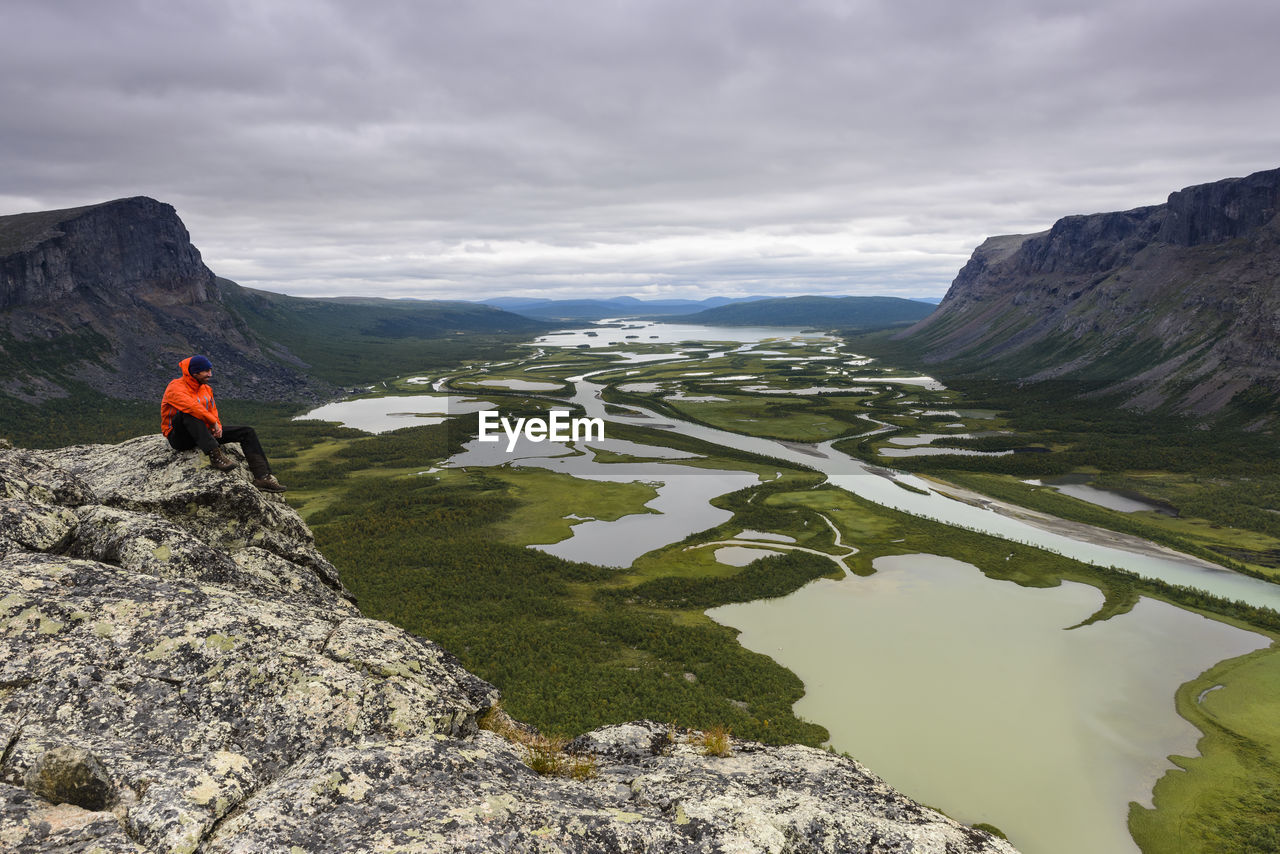 Hiker looking at view from cliff