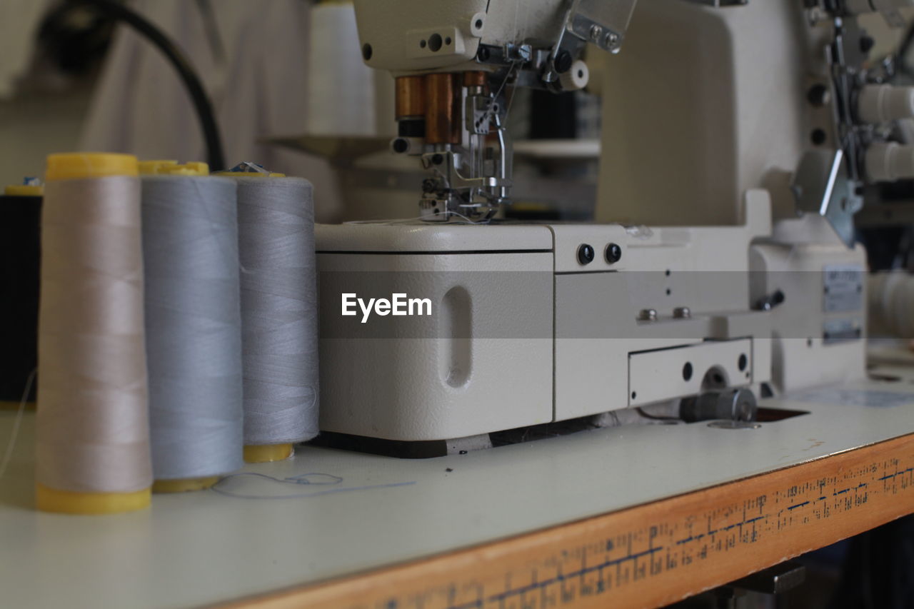 Close-up of sewing machinery at table