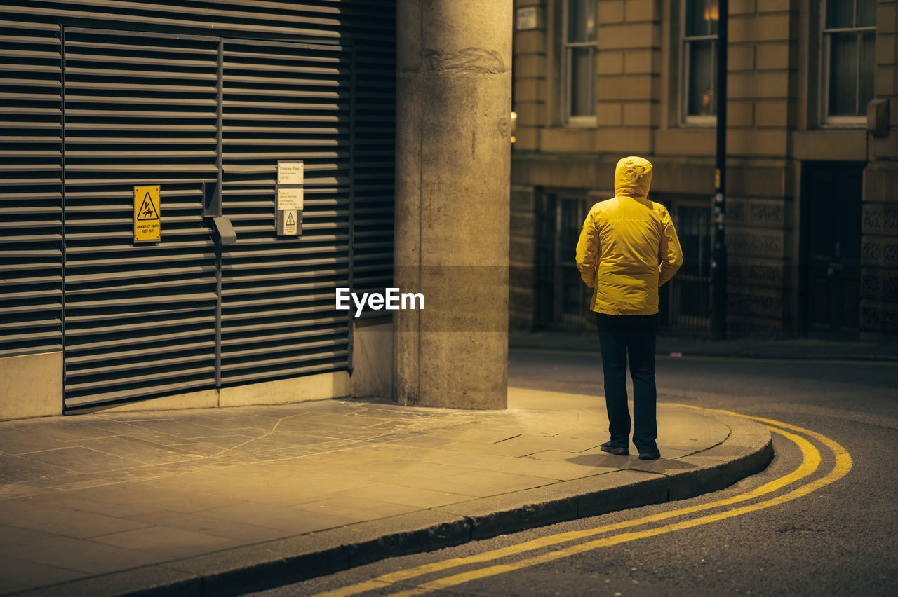 rear view of man walking on road