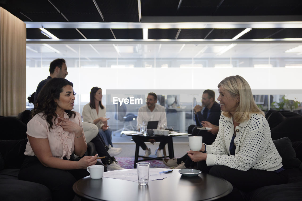 Group of business people having meeting in lobby