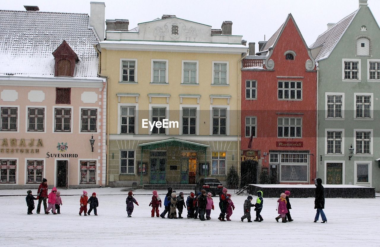 GROUP OF PEOPLE IN CITY DURING WINTER