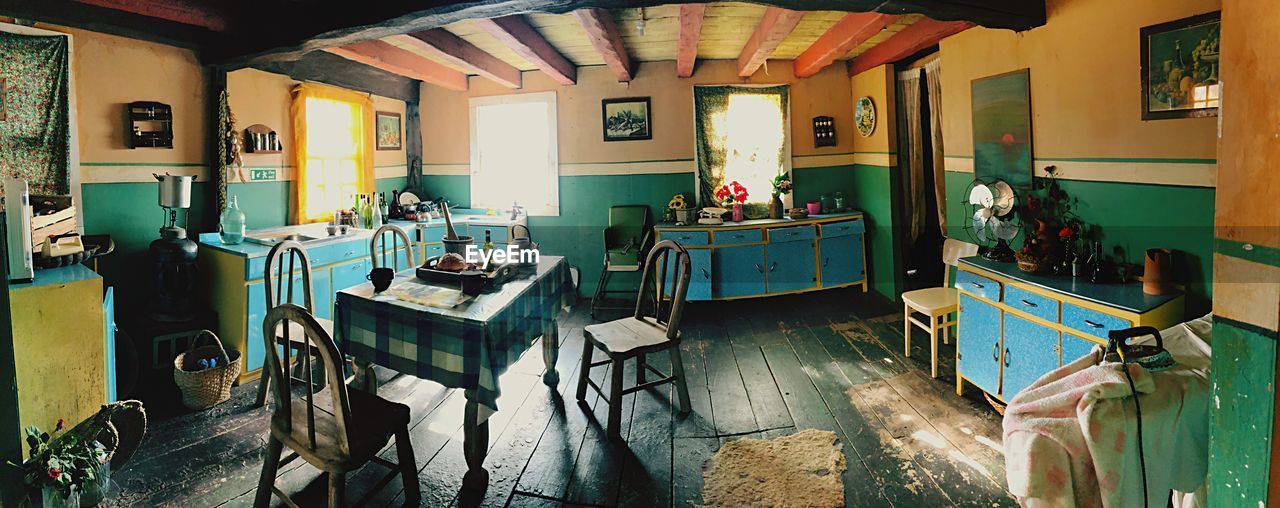 EMPTY CHAIRS AND TABLES IN BUILDING