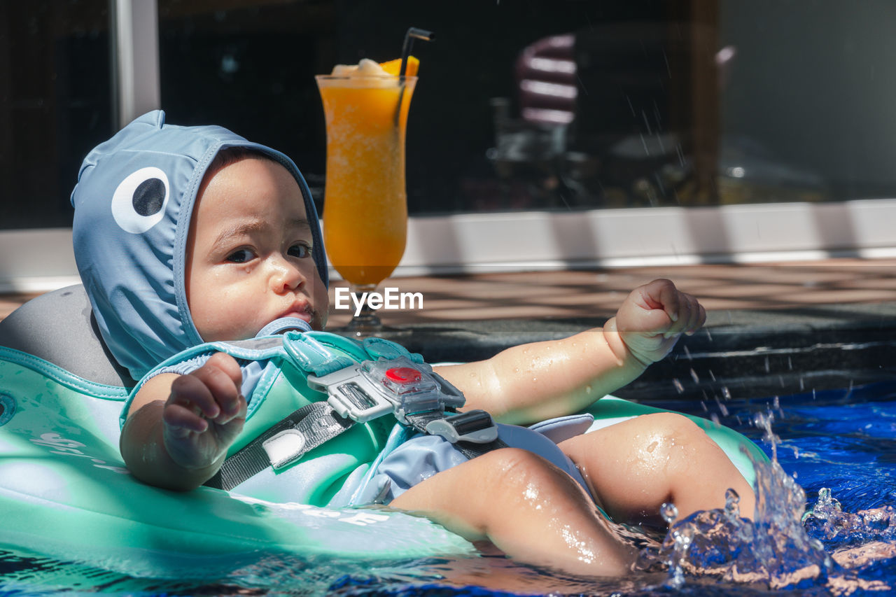 Portrait of boy swimming in pool