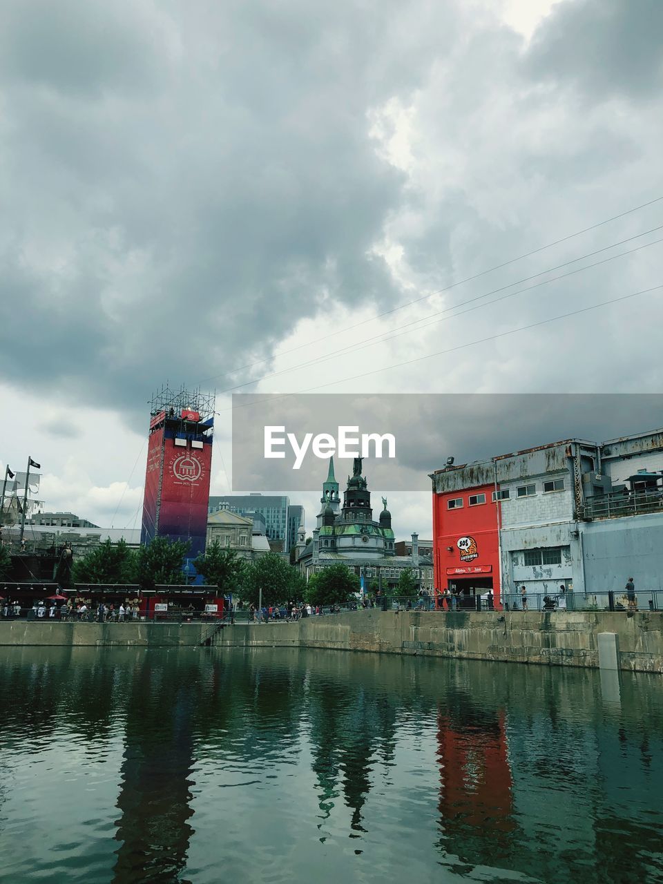 LAKE AND BUILDINGS AGAINST SKY