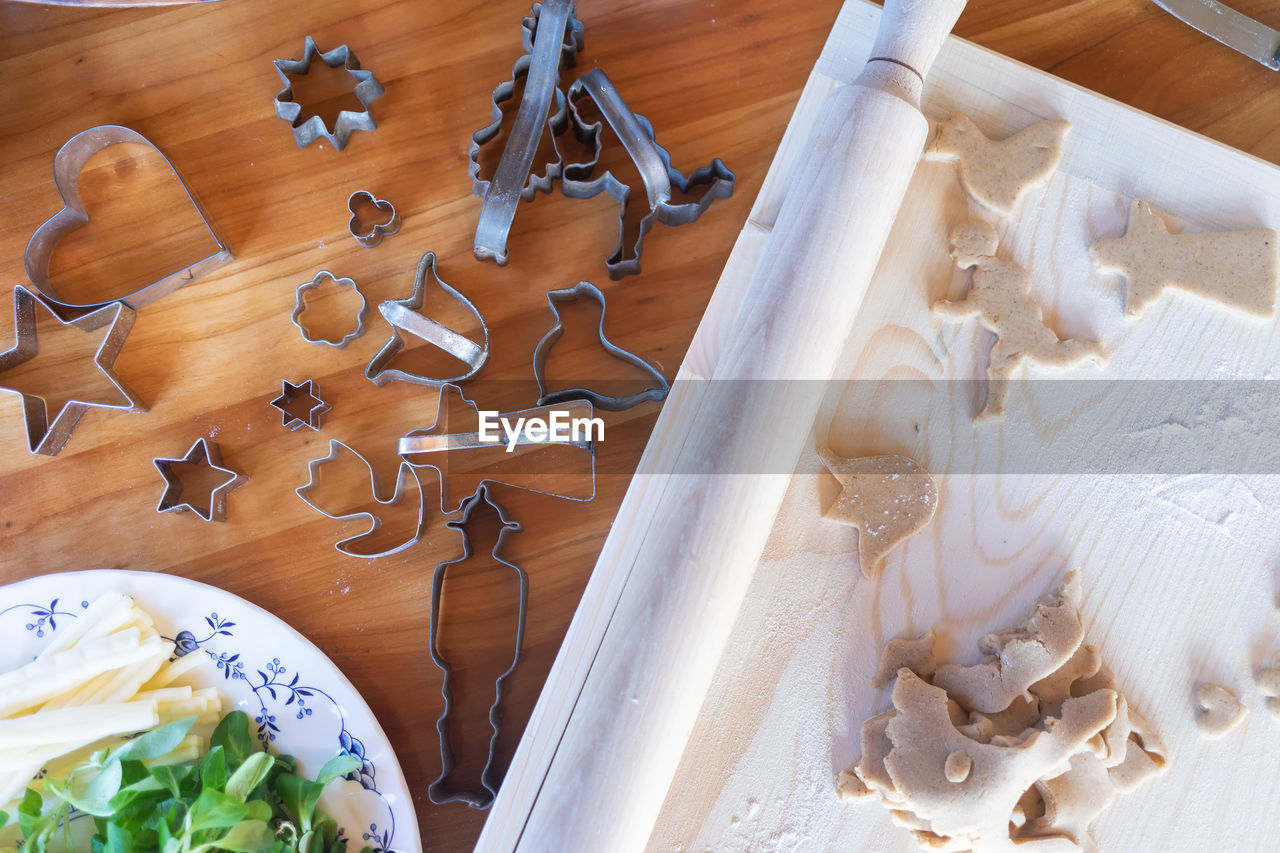 Traditional homemade gingerbread baking. dough cut out, table flat lay view.