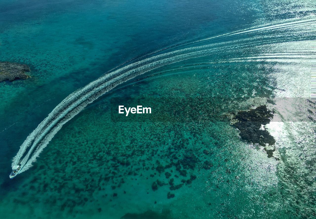 High angle view of sailboat moving on sea