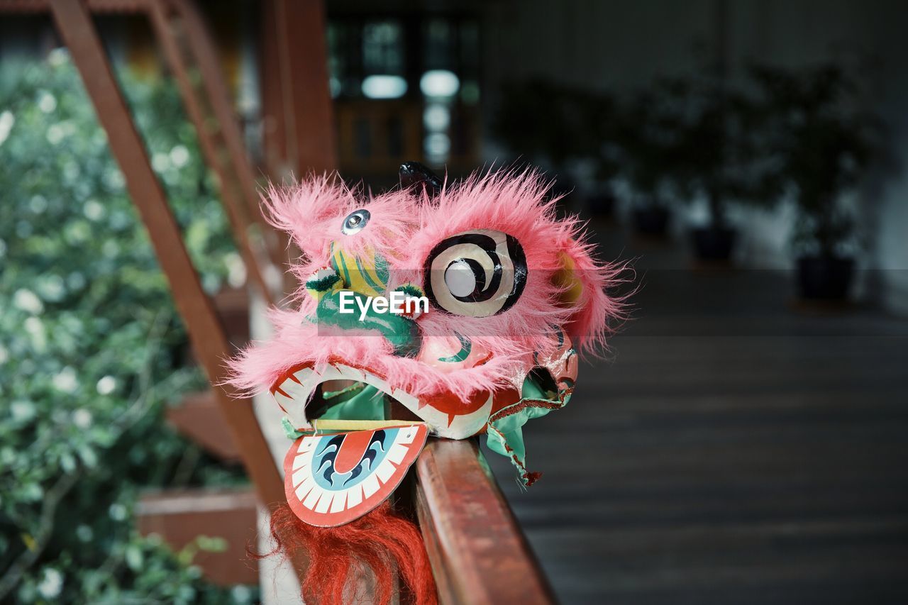 Close-up of mask on railing 