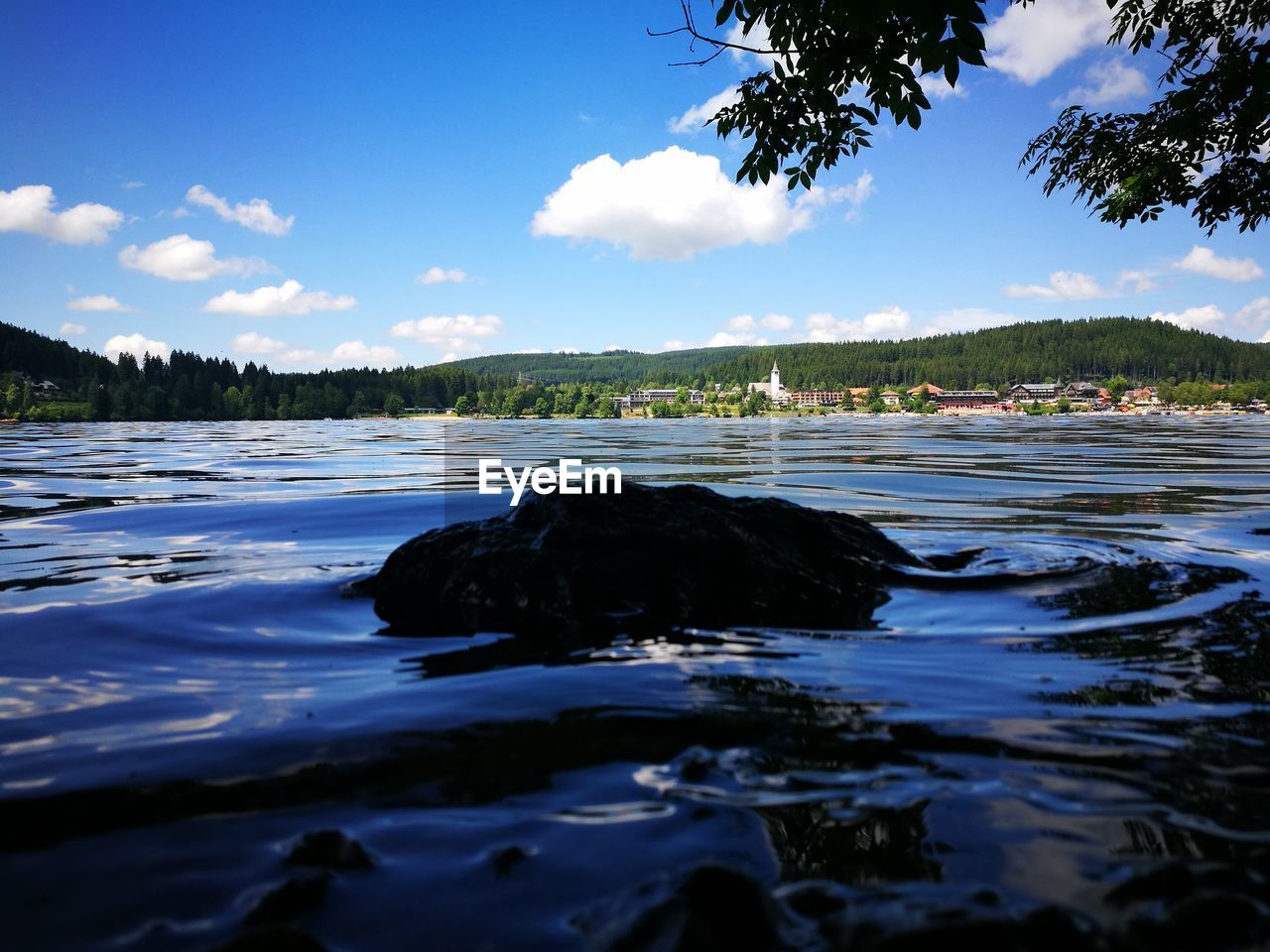 ROCKS IN LAKE AGAINST SKY