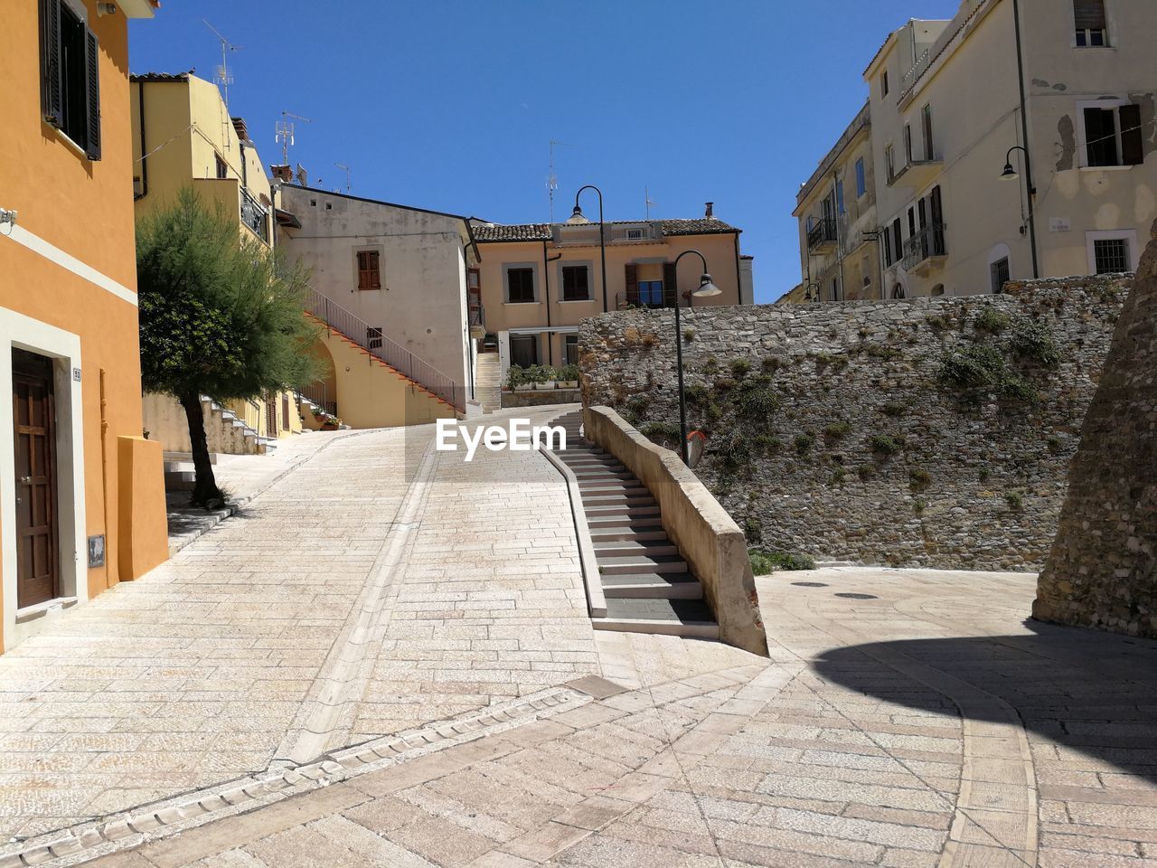 FOOTPATH AMIDST BUILDINGS IN CITY