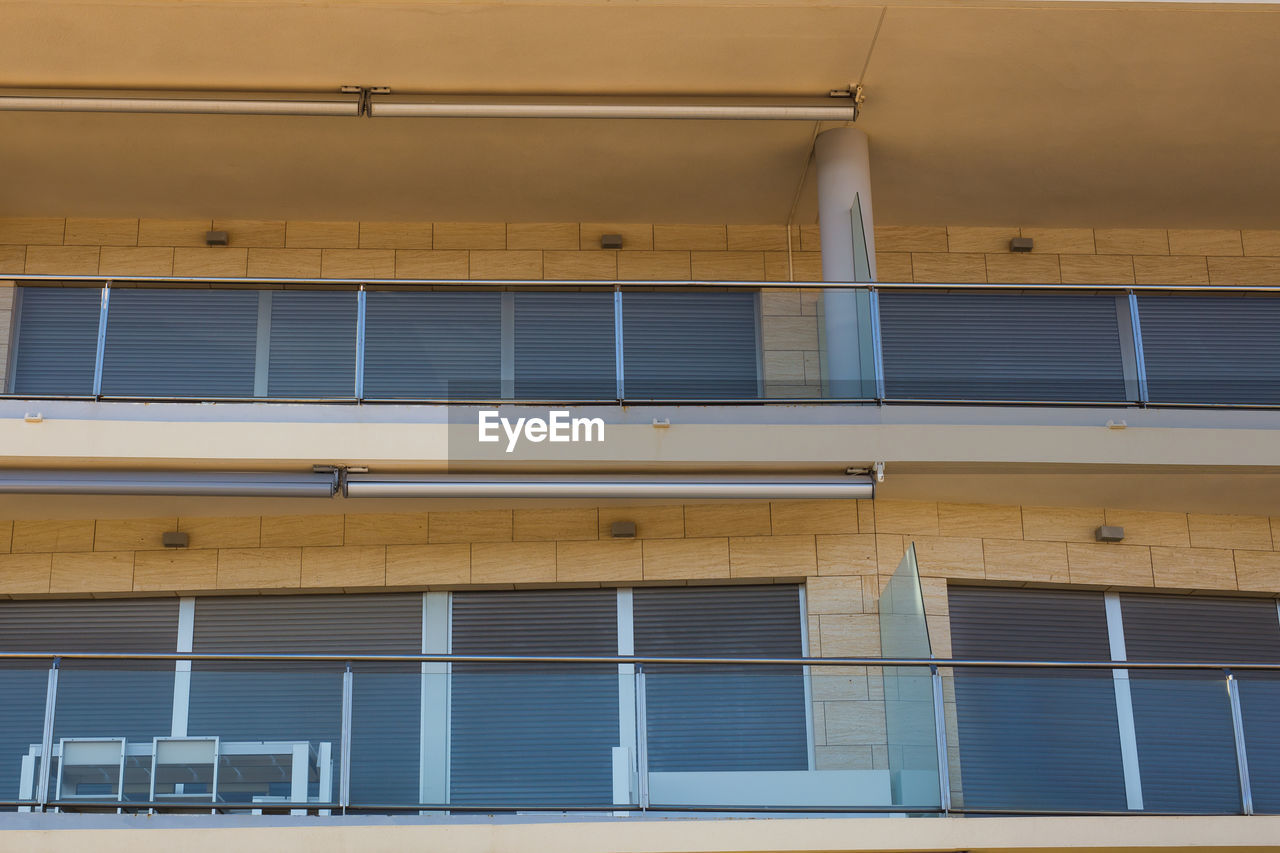 LOW ANGLE VIEW OF YELLOW BUILDING