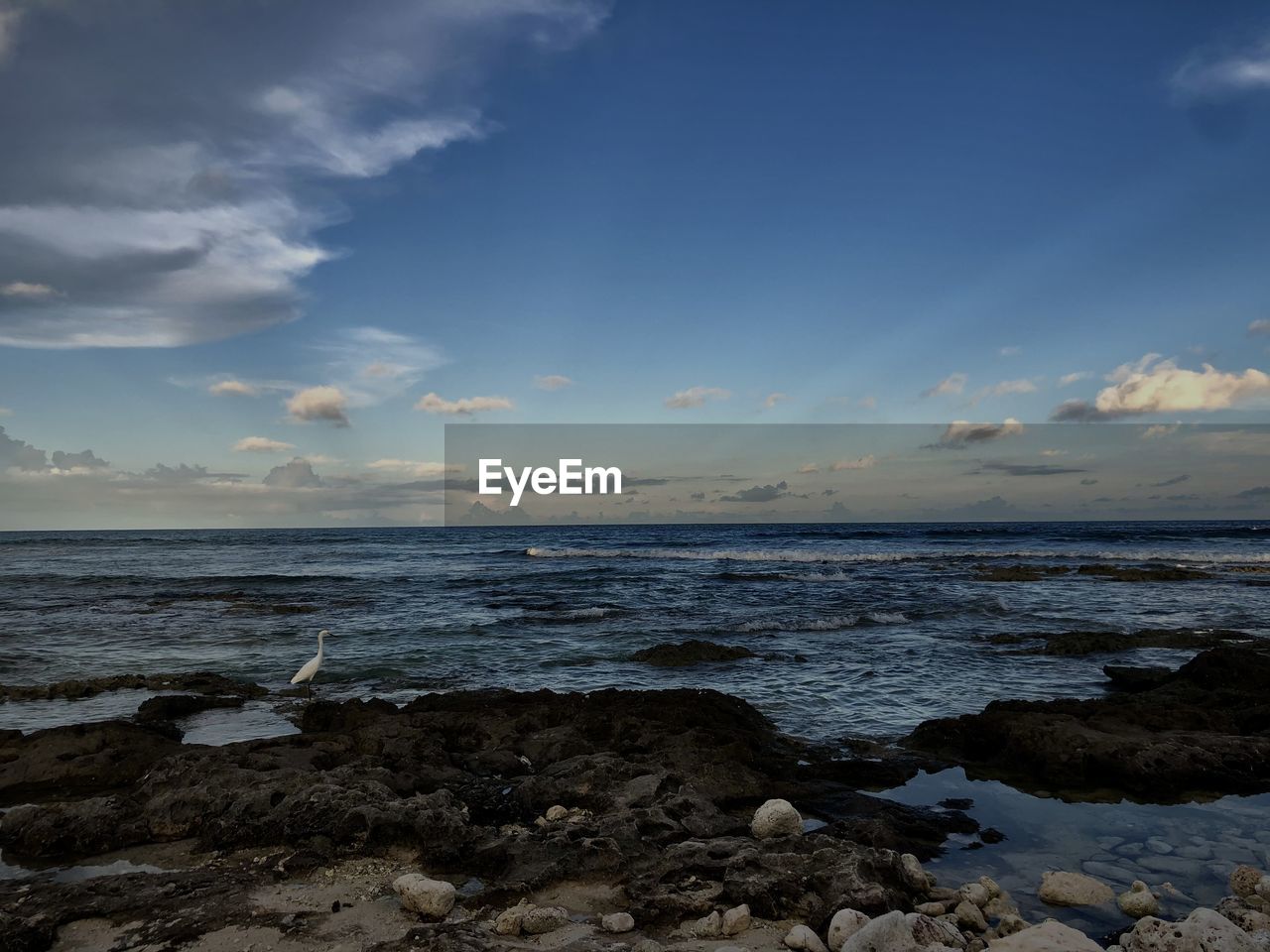 SCENIC VIEW OF ROCKS ON BEACH AGAINST SKY