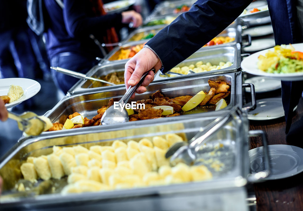 Cropped image of hand taking food