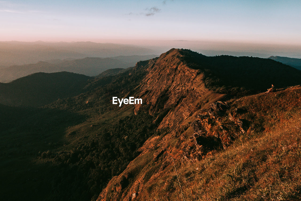 SCENIC VIEW OF MOUNTAIN AGAINST SKY DURING SUNSET