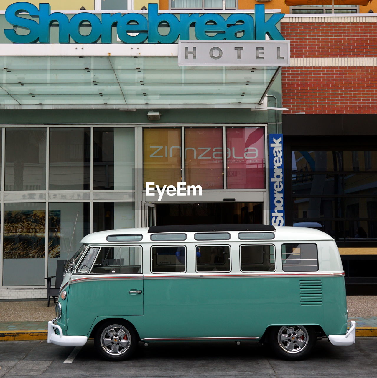 VINTAGE CAR ON STREET AGAINST BUILDINGS