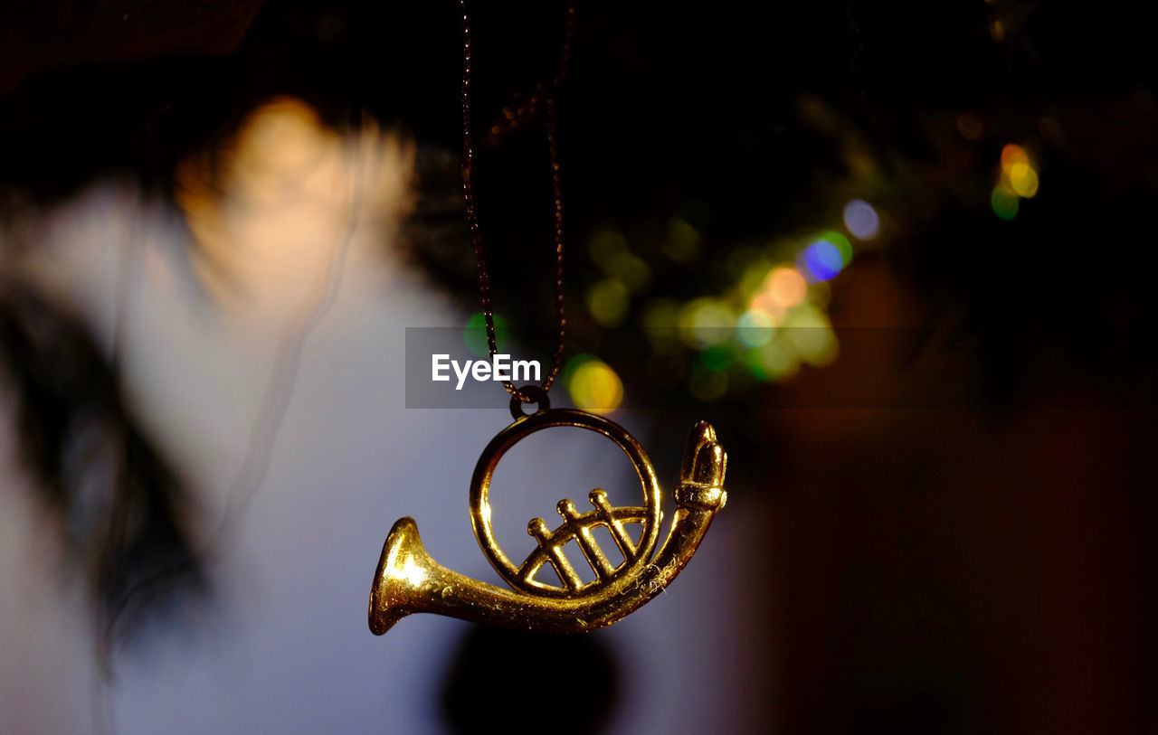 Close-up of trumpet decoration hanging outdoors at night