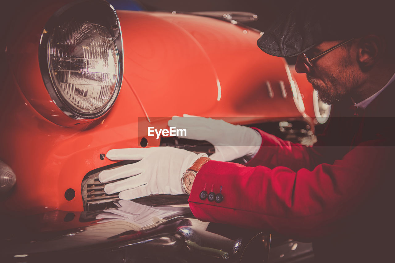 Cropped hand of man holding car