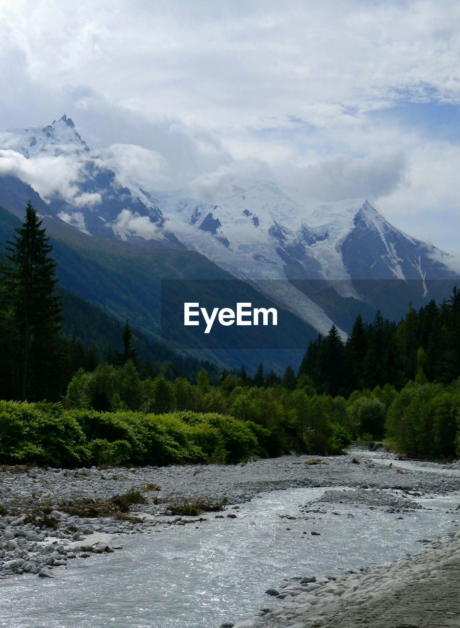 Scenic view of river and mountains against sky