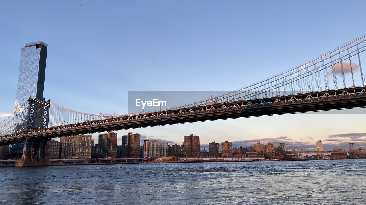 architecture, built structure, bridge, city, transportation, water, sky, travel destinations, building exterior, suspension bridge, cityscape, nature, cable-stayed bridge, travel, urban skyline, landscape, tourism, building, city life, engineering, river, office building exterior, skyscraper, downtown district, landmark, clear sky, outdoors, business finance and industry, residential district, street, beauty in nature, bay, copy space, waterfront, blue, scenics - nature, mode of transportation, dusk, road, bay of water, business, day, tranquility, panoramic, environment, cloud, twilight, motion, arch bridge, sunlight