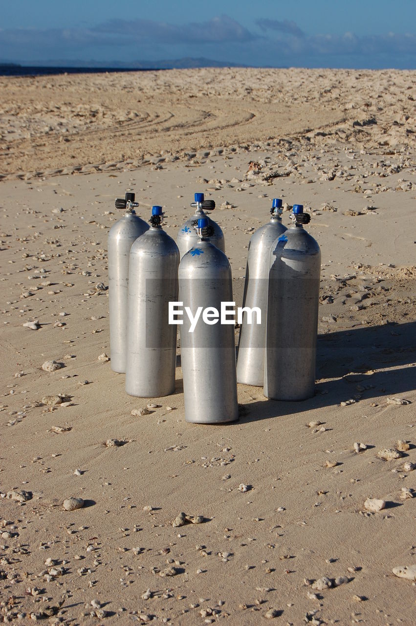 Scuba tanks on sand at beach