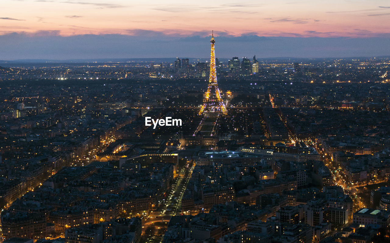 Aerial view of city lit up at night