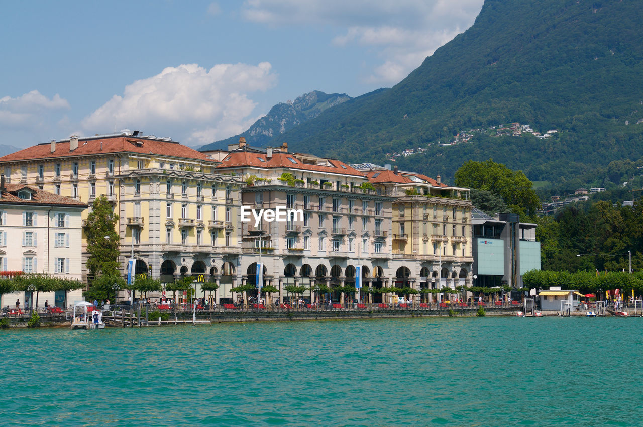 Beautiful view of some old buildings of lugano switzerland seen from the lake on  summer