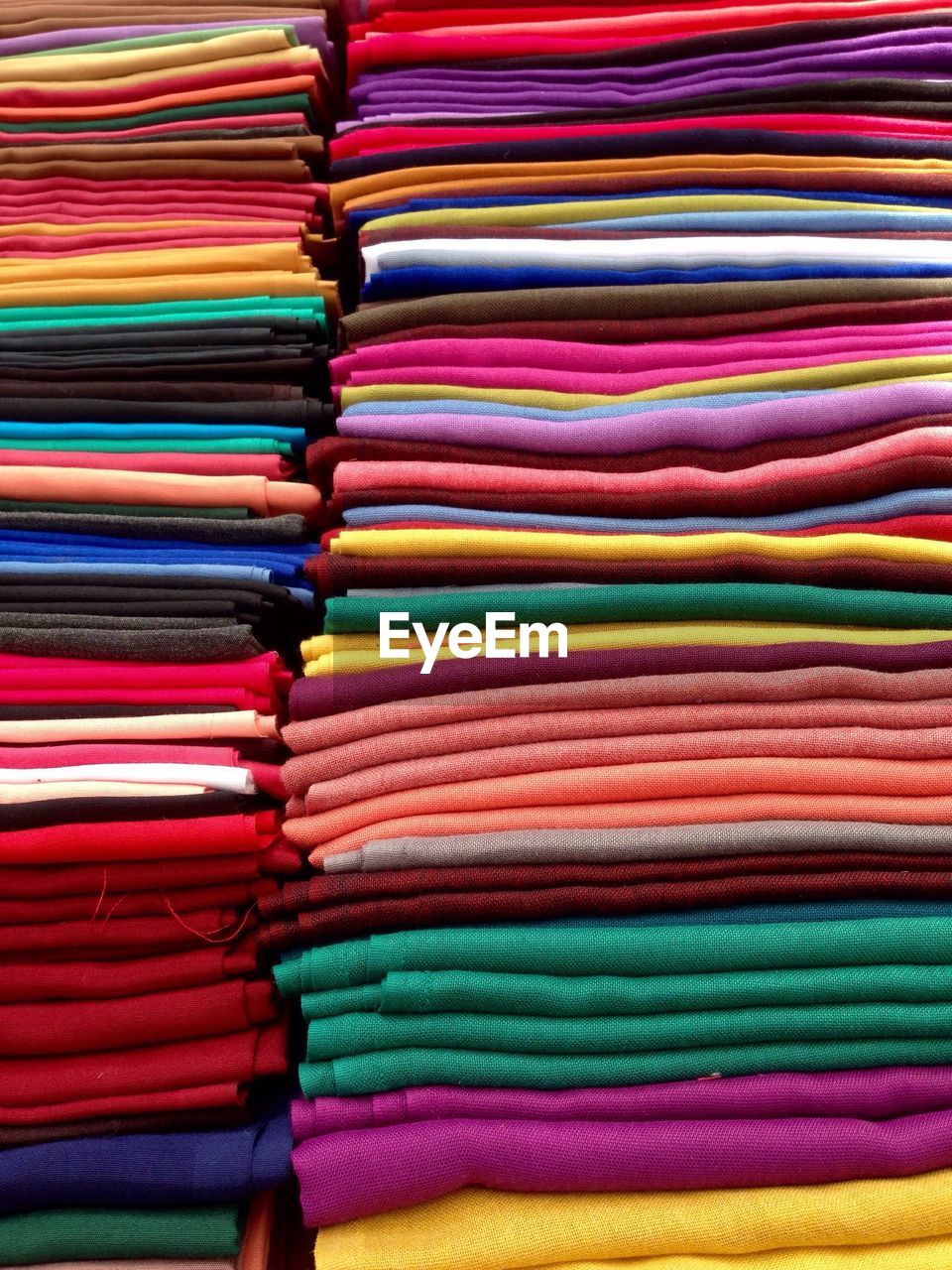 Full frame shot of stacked textiles for sale at market stall