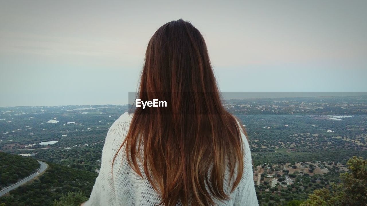 Rear view of woman looking at cityscape