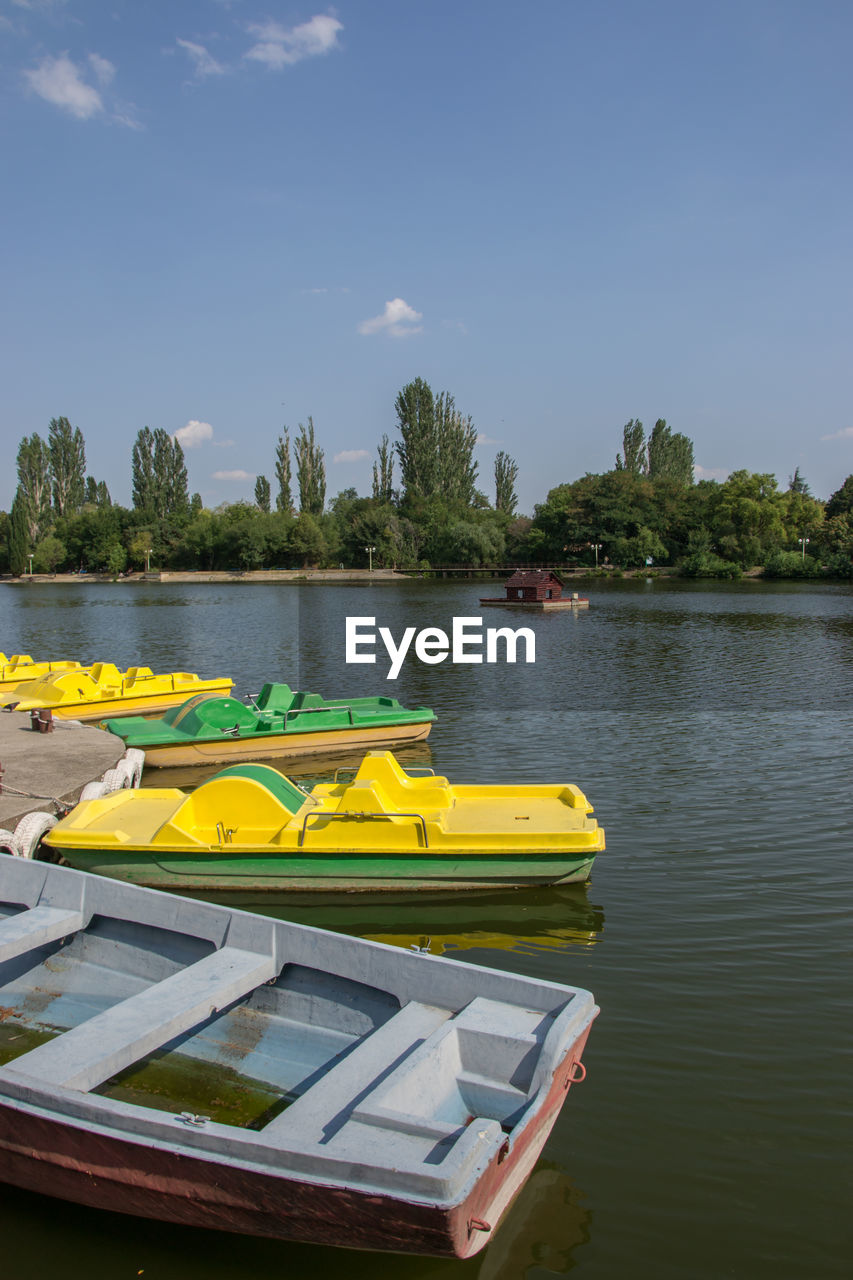 YELLOW BOAT FLOATING ON LAKE