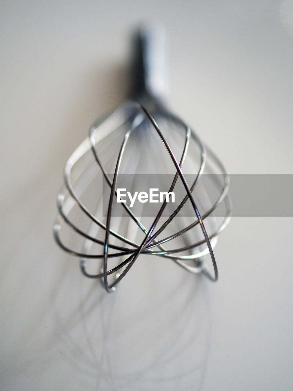 Close-up of wire whisk on table