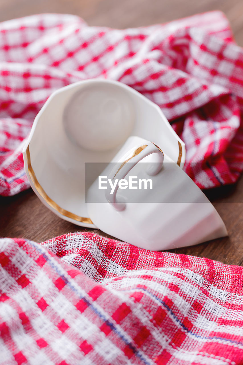 pink, food and drink, checked pattern, dish towel, food, indoors, crockery, tablecloth, no people, red, coffee cup, tableware, studio shot, cup, kitchen utensil, textile, pattern, close-up, drink, mug, wood, eating utensil, sweet food