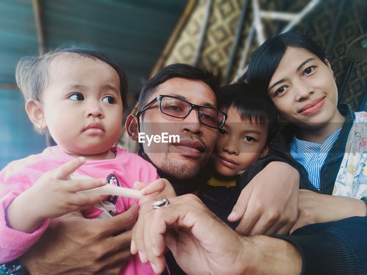 Portrait of parents with children at home