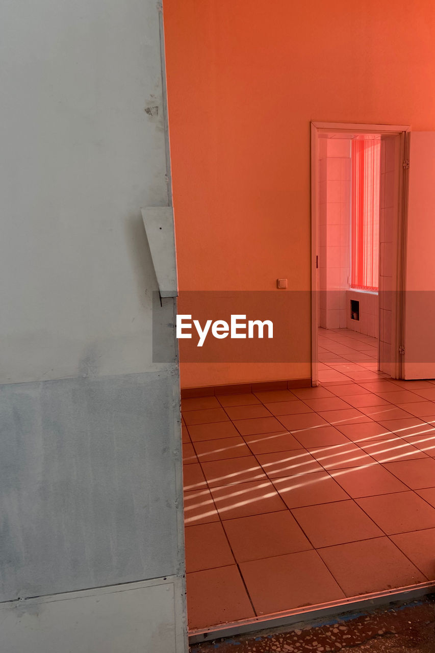 floor, red, architecture, door, entrance, wall, house, flooring, wall - building feature, room, building, no people, built structure, indoors, interior design, orange color, home interior, wood, doorway, arcade, corridor