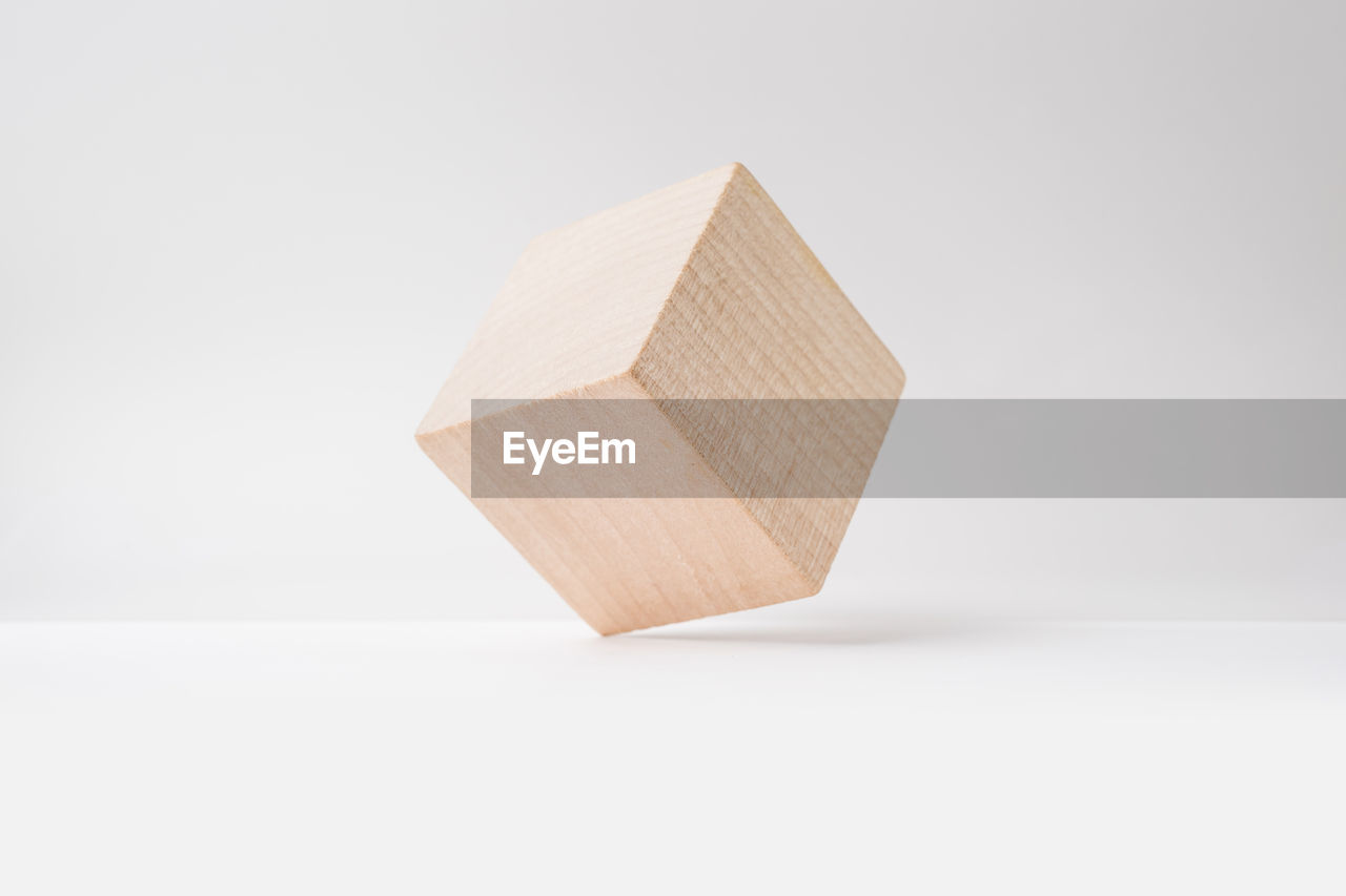 Close-up of wooden cube shape against white background