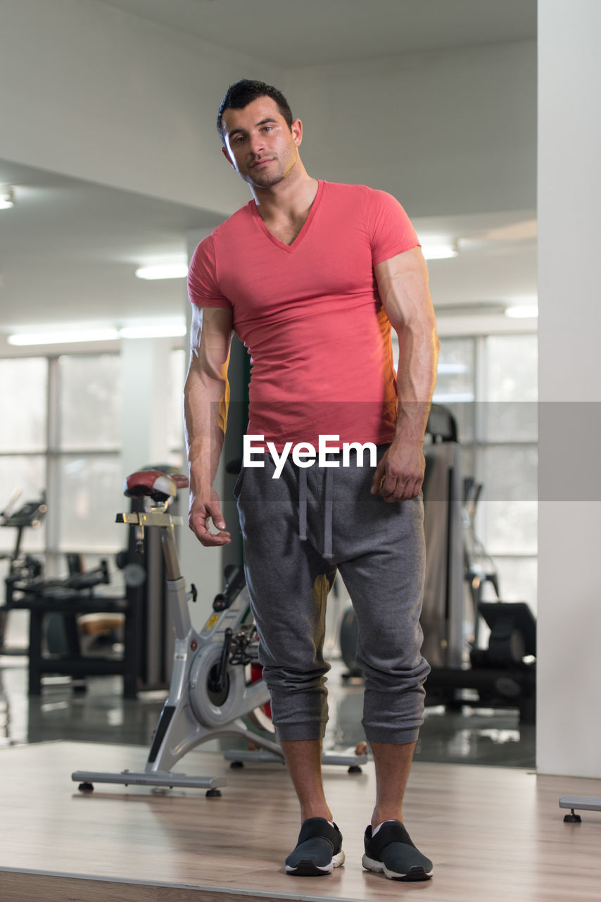 Muscular man standing in gym