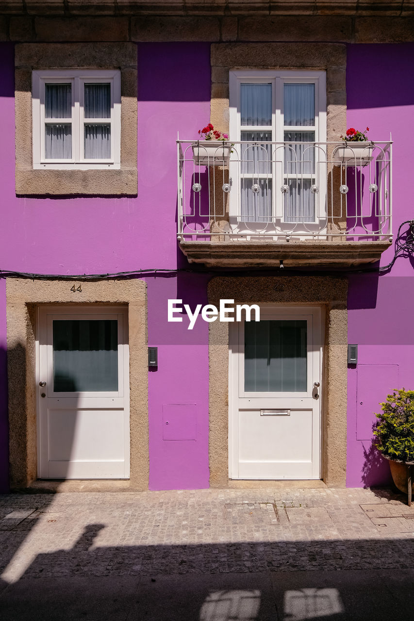 FACADE OF BUILDING WITH PINK WINDOWS