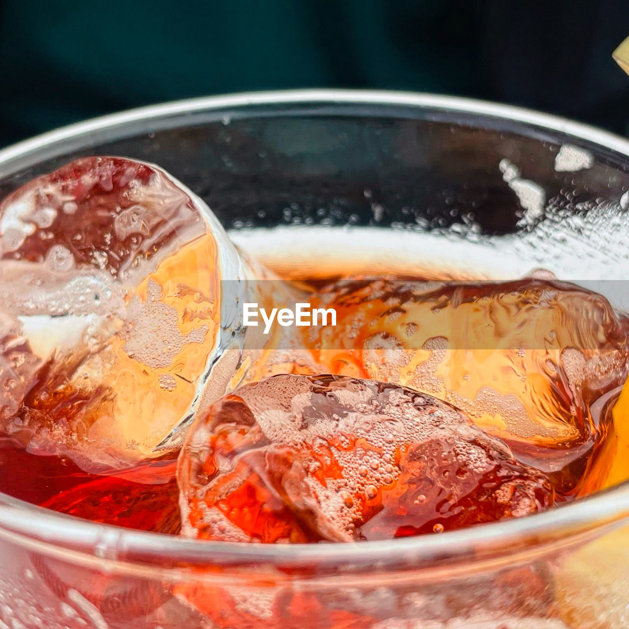 Close-up of drink with bug ice cubes on table