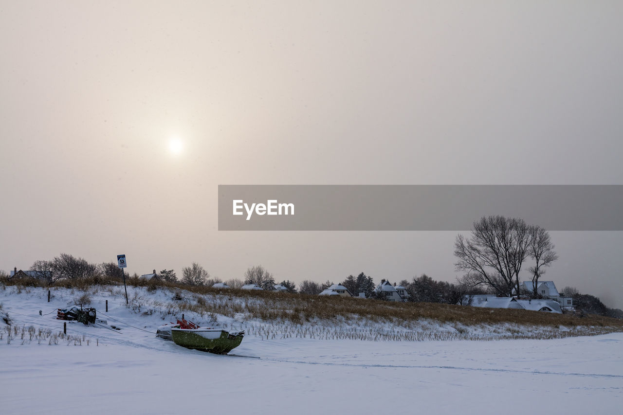 Scenic view of snowy field against clear sky during winter
