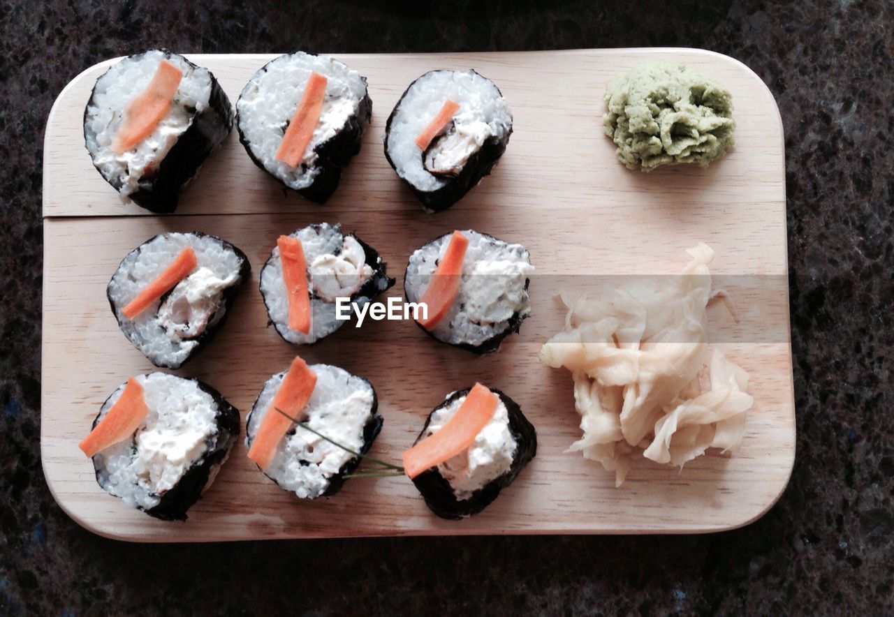 Directly above shot of sushi served on wooden plate