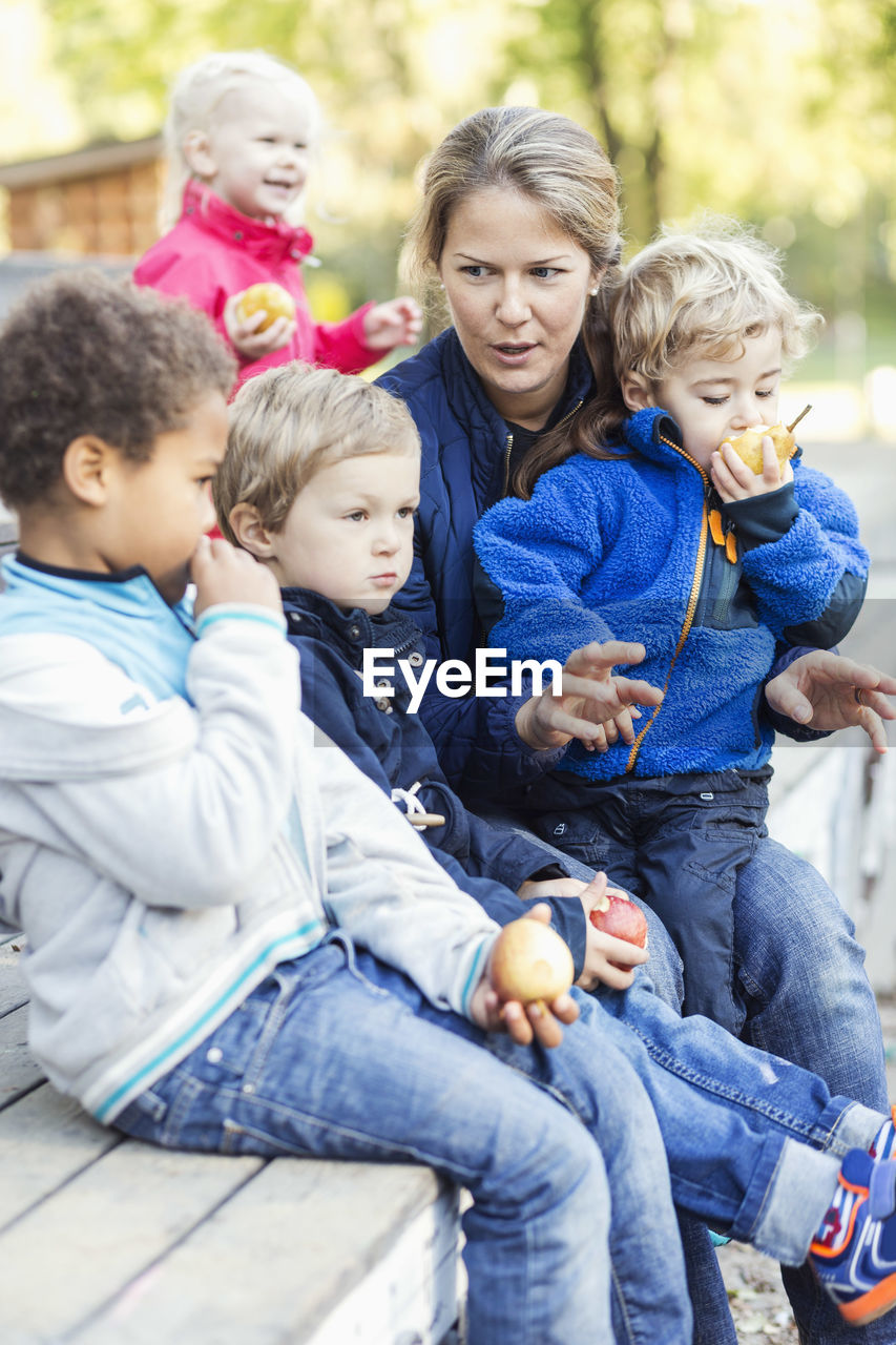 Teacher with children outside kindergarten