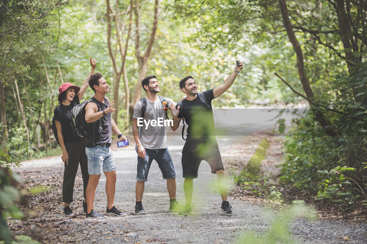 Friends taking selfie in forest
