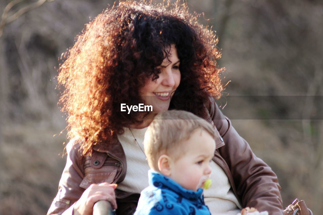 Mother with curly hair by baby boy