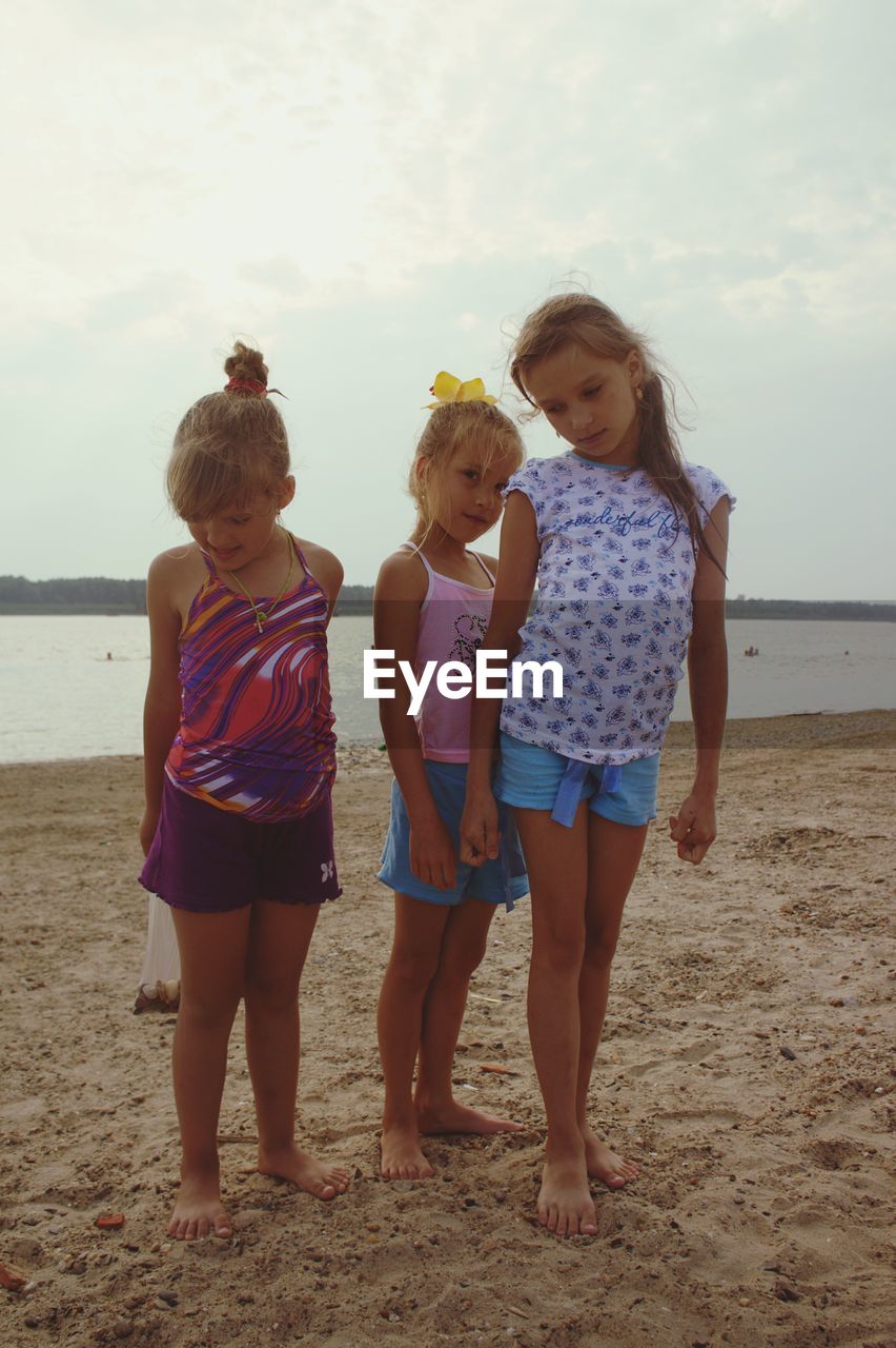 Sisters standing at beach