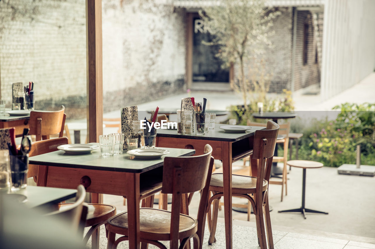 Empty chairs and tables in cafe