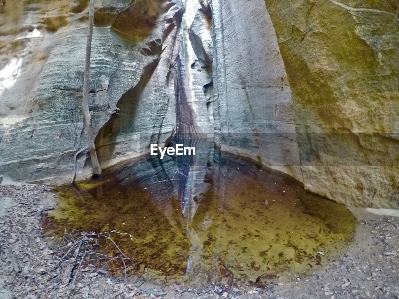 CLOSE-UP OF ROCKS BY WATER