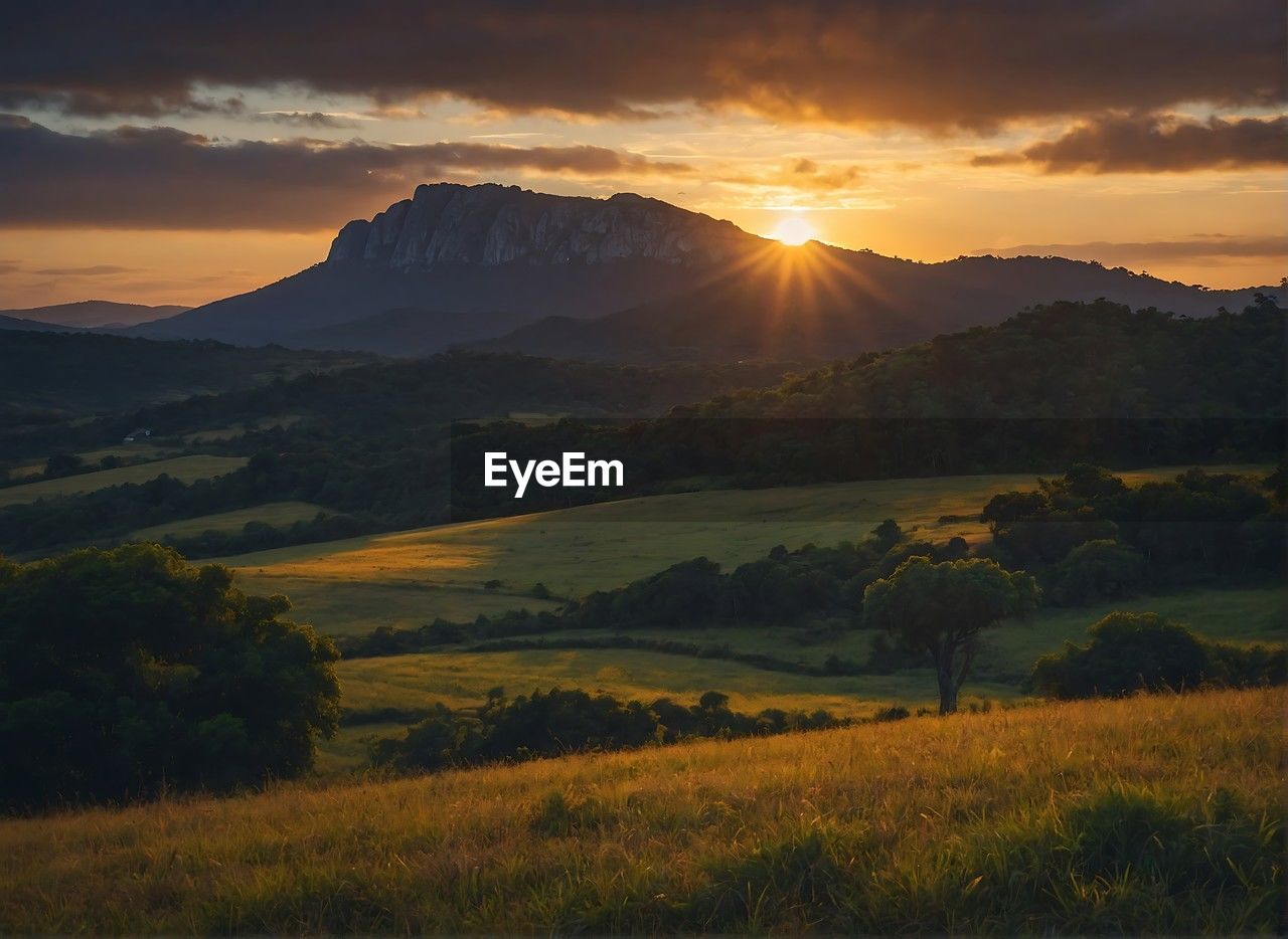 scenic view of landscape against sky during sunset