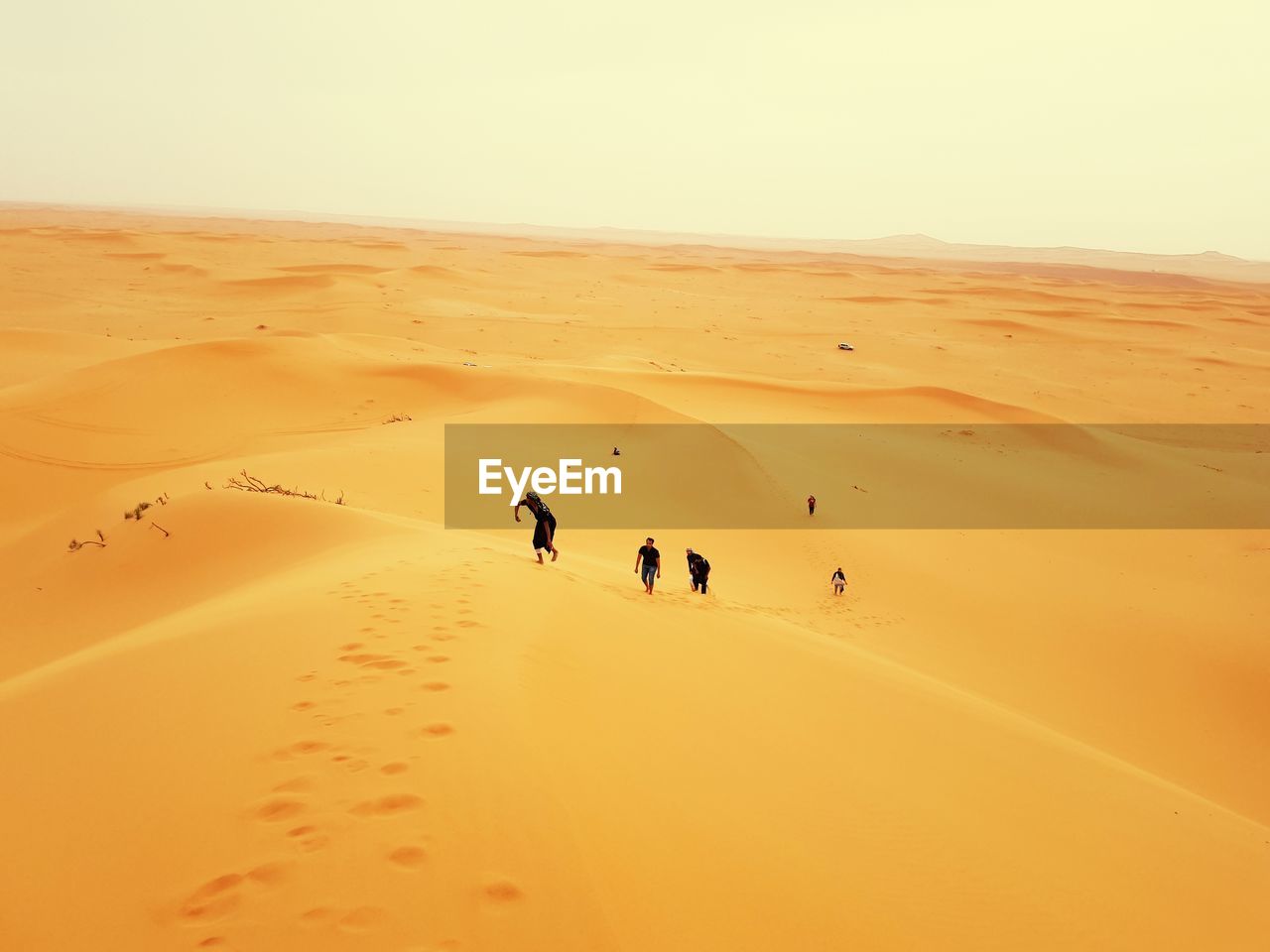 High angle view of people walking at desert against sky