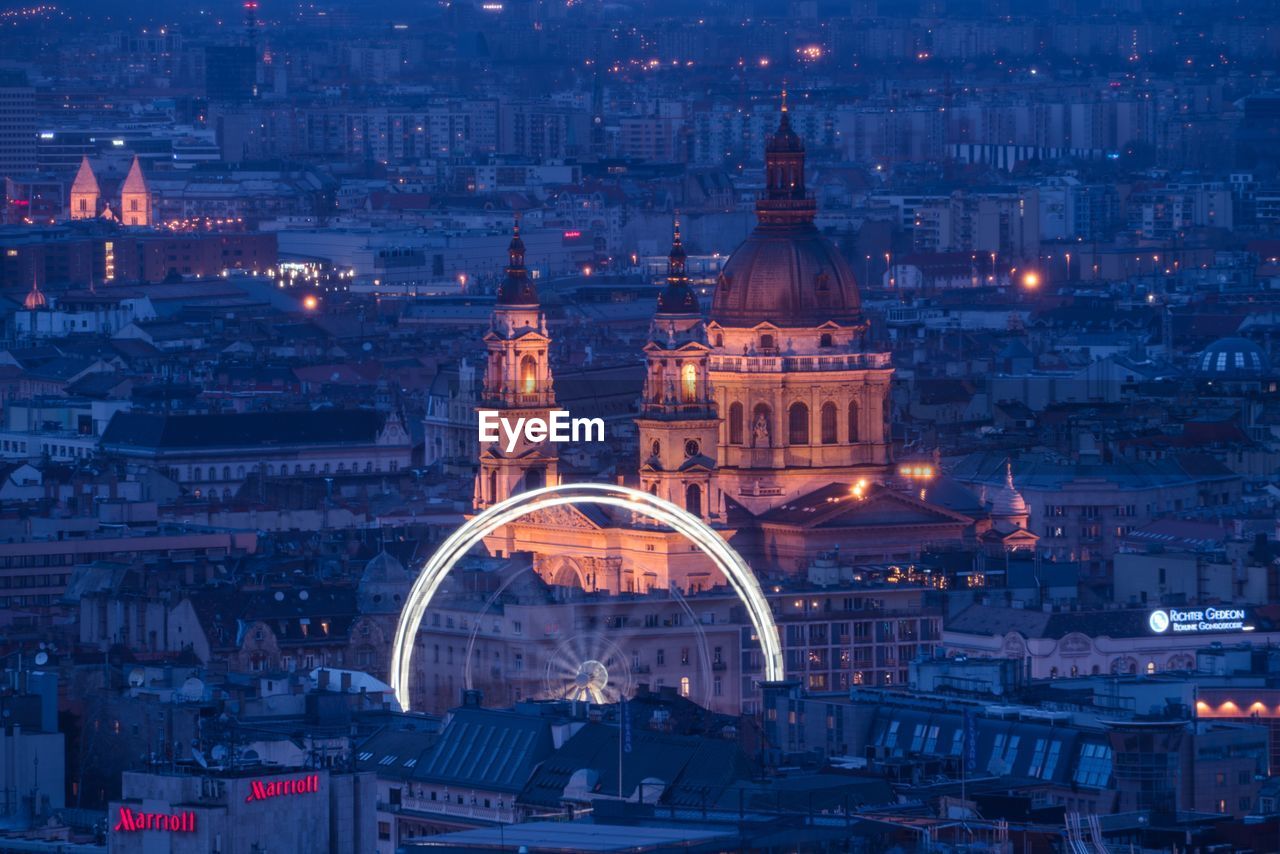 ILLUMINATED BUILDINGS AGAINST SKY AT NIGHT